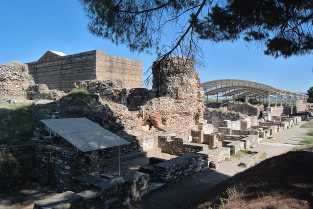 Ruins at Sardis with shops in the foreground, a gymnasium on the left, and a synagouge on the right.