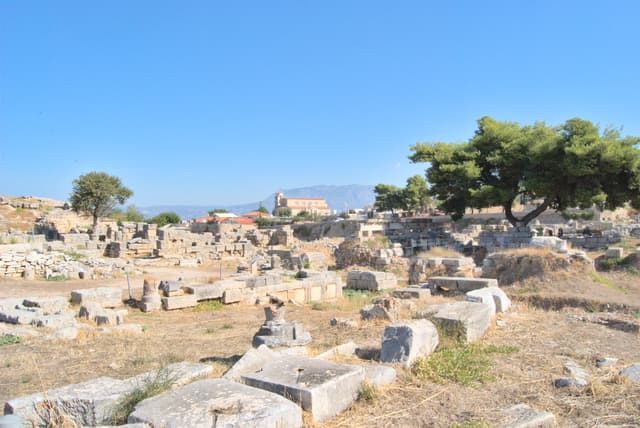Ruins of ancient Corinth with a more recent church of St Paul in the background